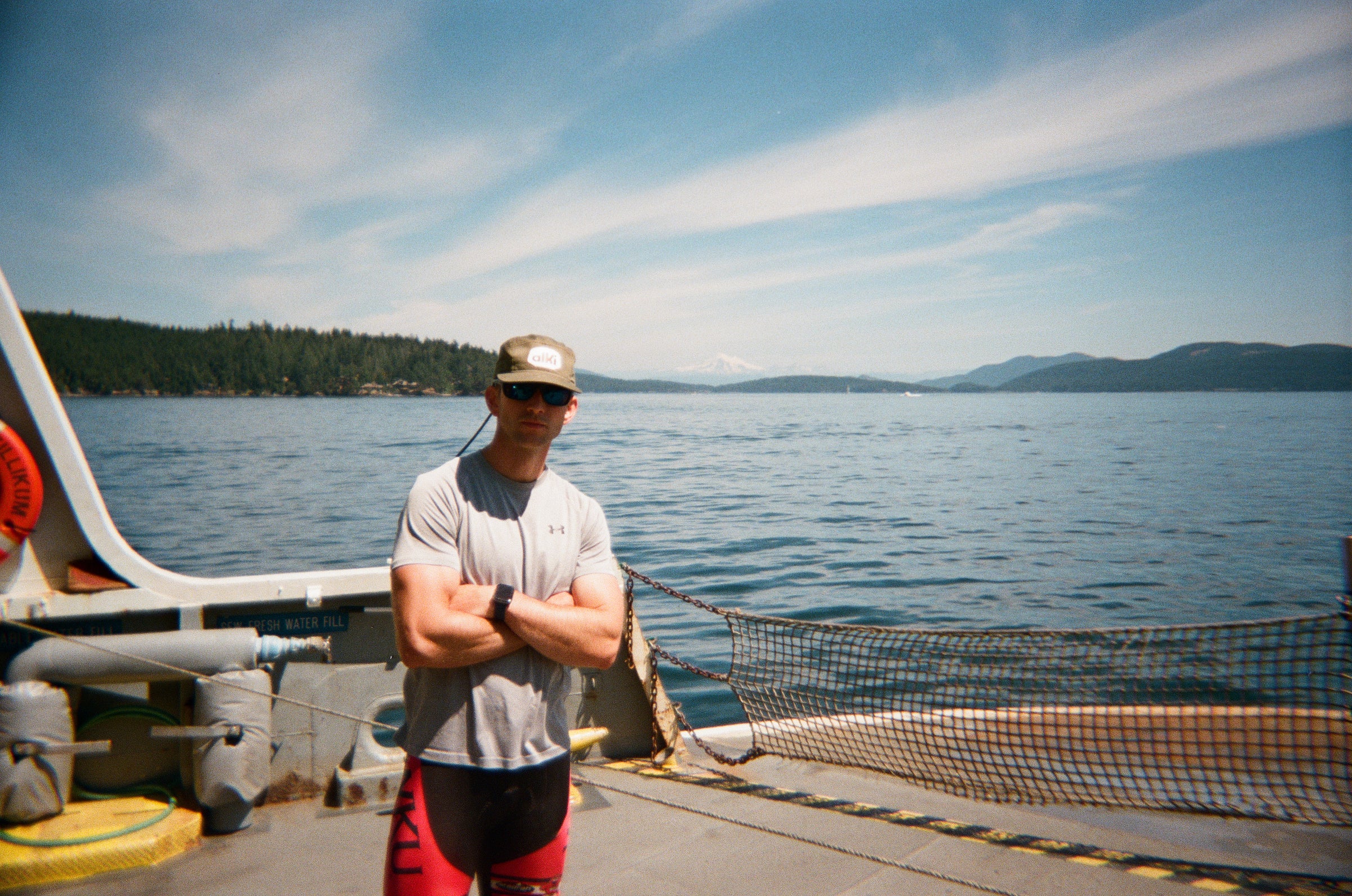 Chaz wearing his Alki Supply hat on the ferry with Mt. Baker in the distance