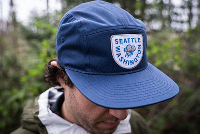 model wearing Navy blue raincloud Seattle Hat