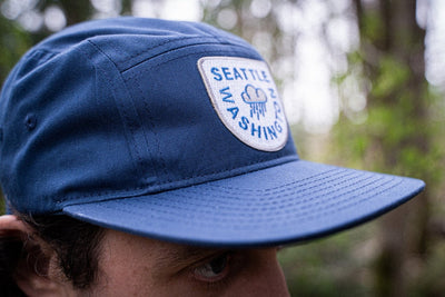 model wearing Navy blue raincloud Seattle Hat